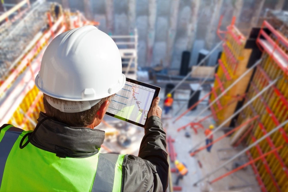 Busy construction site with heavy equipment and workers, illustrating the risks and complexities involved in understanding construction accidents in Brownsville.