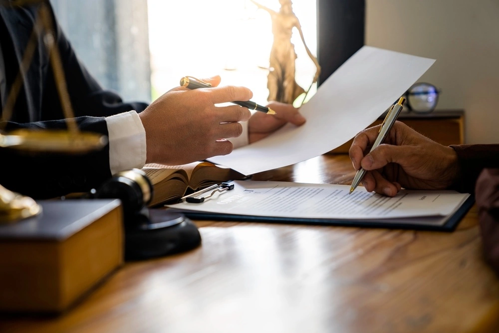 Motorcycle accident attorney meeting with an injured rider, illustrating how legal advocates challenge unfair motorcycle bias in insurance claims.