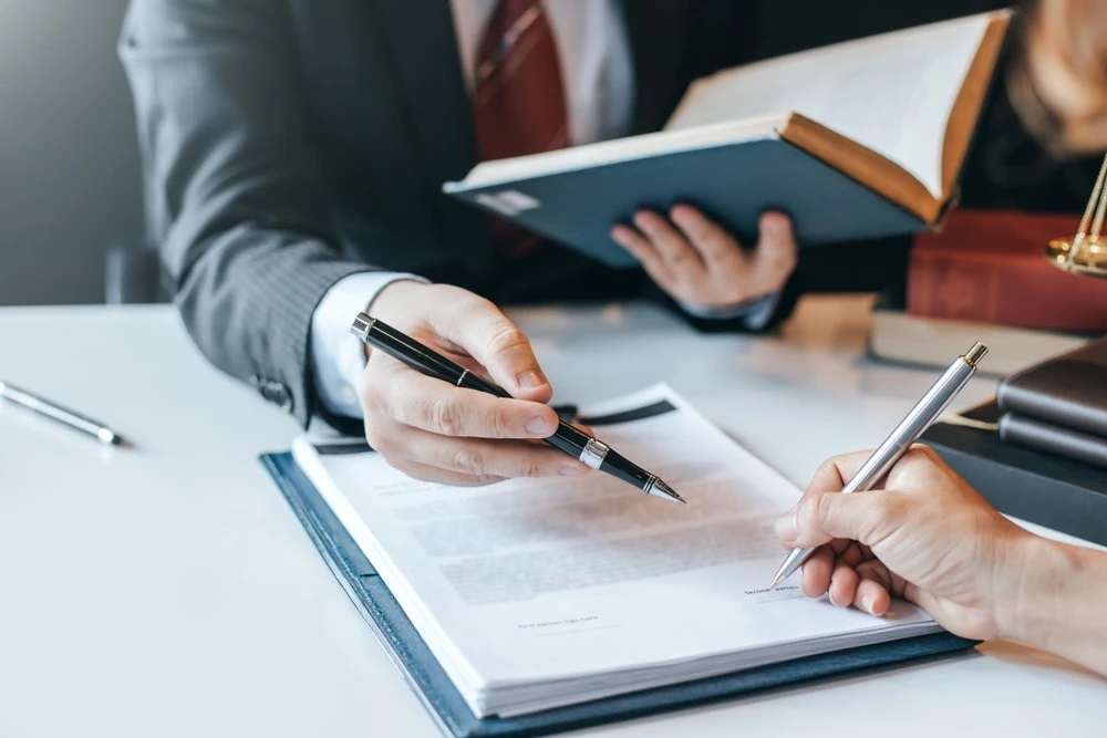 Client working with a Brownsville internal injury lawyer in an office, illustrating why individuals choose Kenny Perez Law for dedicated representation in an internal injury case.