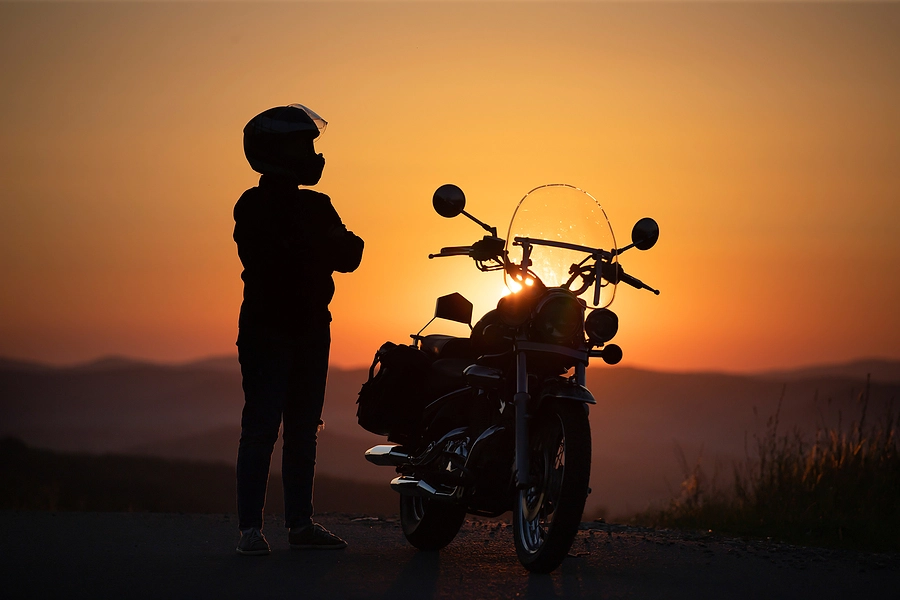 Person standing beside a motorcycle at the roadside, illustrating the investigation of a Dallas motorcycle crash.