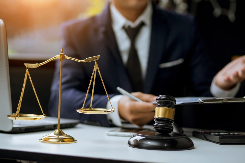 Houston hit and run lawyer at Kenny Perez Law consulting with a client in an office, illustrating trusted representation for Houston hit and run cases.