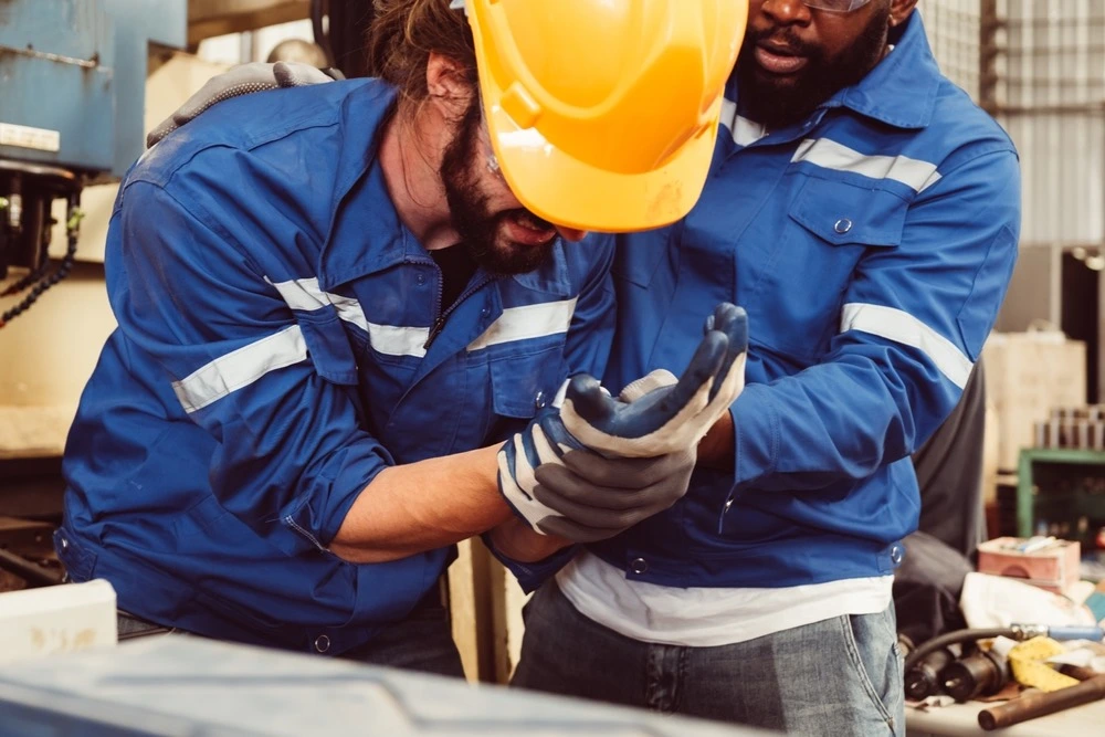 Construction worker with an injured hand at a job site, illustrating the serious nature of burn injuries in McAllen.