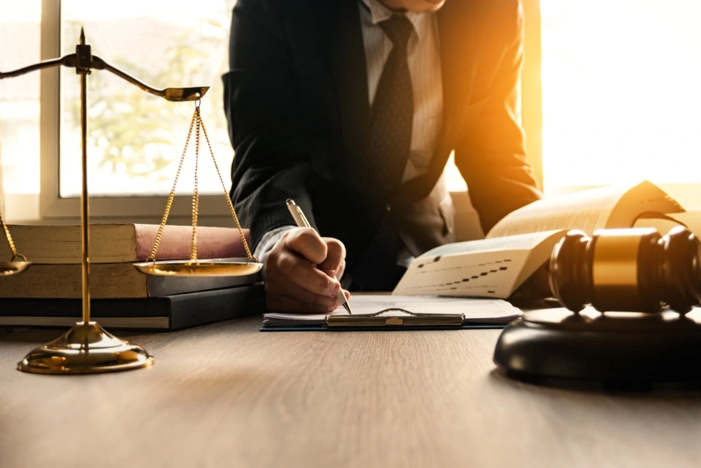 McAllen spinal cord injury lawyer reviewing case documents in an office, highlighting trusted legal representation from Kenny Perez Law for spinal cord injury claims.