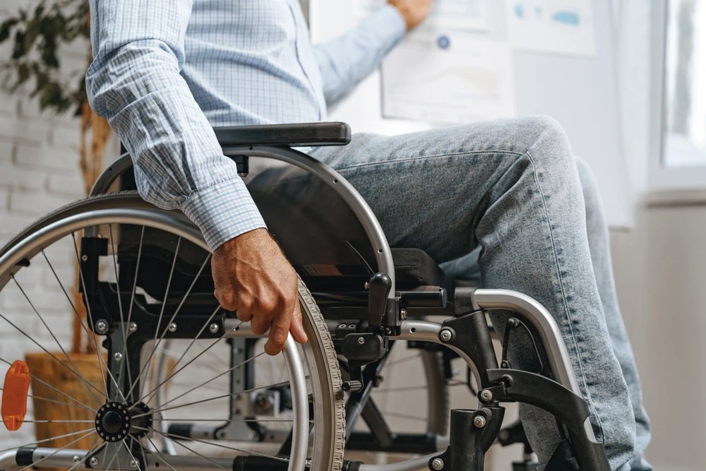 Person in a wheelchair, illustrating the long-term medical care, rehabilitation, and life-changing costs associated with catastrophic injuries.