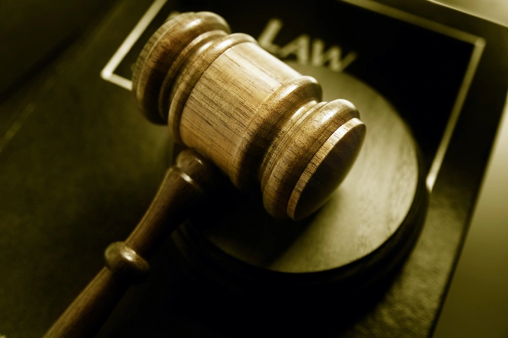 Courtroom gavel resting on a law book, illustrating Texas laws that affect a Mission personal injury claim.