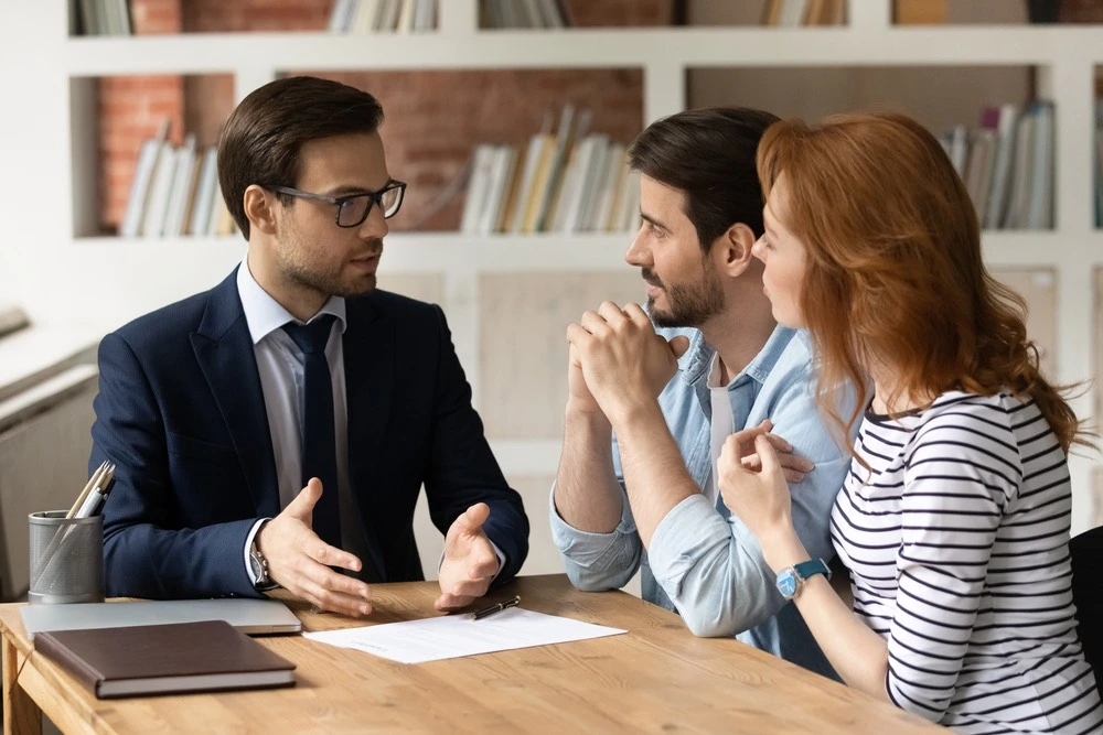 Family consulting with a personal injury lawyer in an office, illustrating why Mission families choose Kenny Perez Law for trusted legal representation.