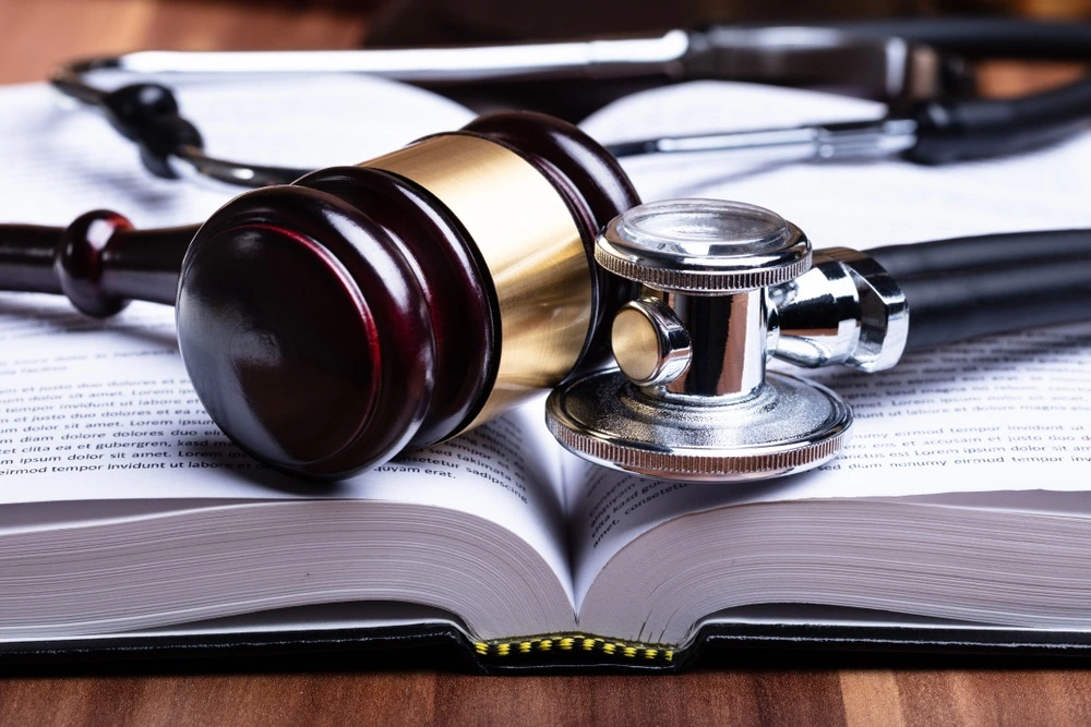 Law book, gavel, and stethoscope arranged on a desk, representing personal injury cases in Port Isabel and the intersection of legal and medical issues.