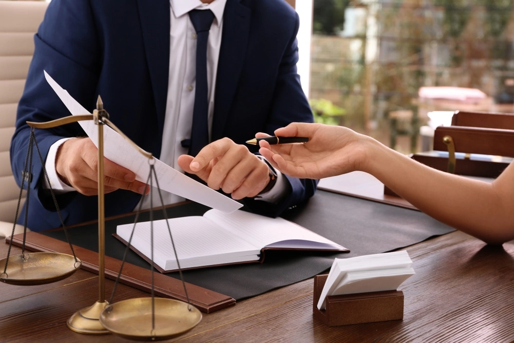 Client working with a Rio Grande City personal injury lawyer while reviewing documents, illustrating how personal injury claims work in Texas.